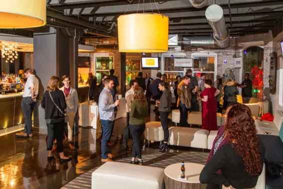 People gather and talk at a Back to Michigan networking event