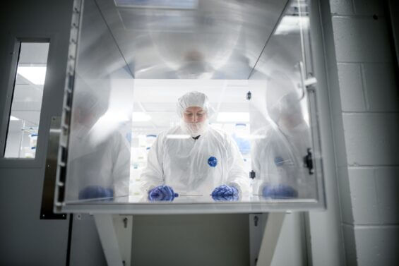 Woman analyzes sample in lab oven.