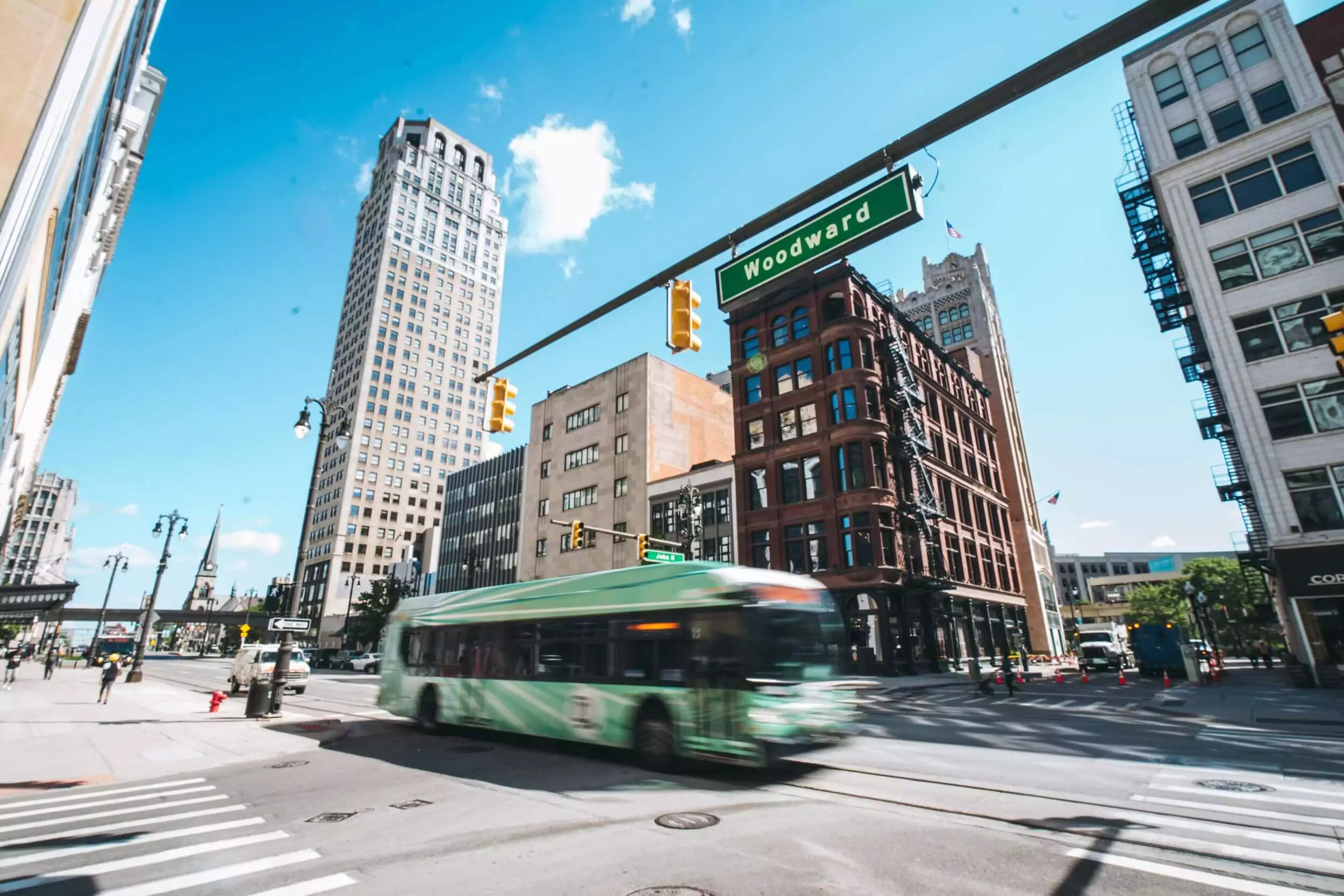 City bus driving down Woodward street in downtown.