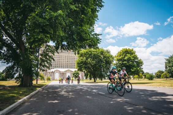 Group of people bike together through the Detroit neighborhood of Corktown.