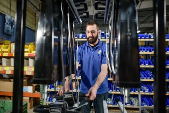 Man manufacturing motorized shopping carts