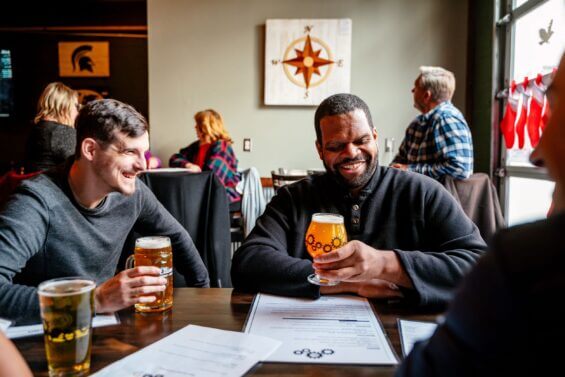 Group of friends enjoy beers at a brewery.