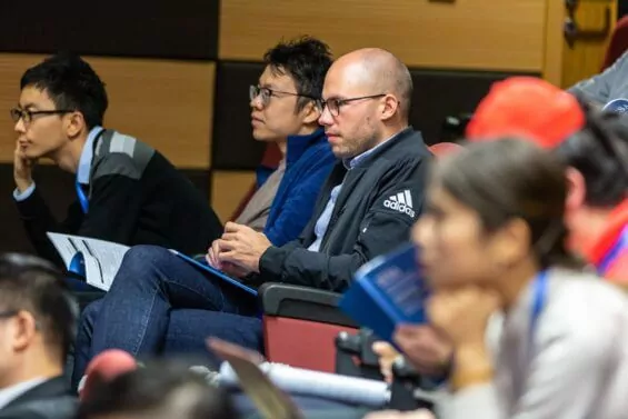 Close-up of students sitting in auditorium for class.