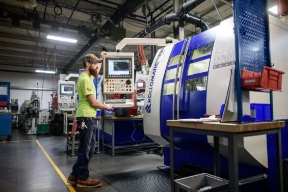 Man operating medical manufacturing machine.