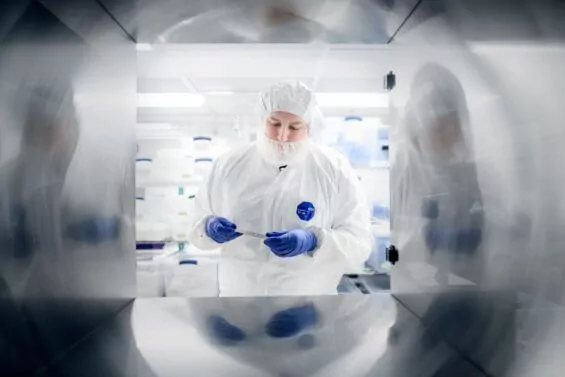 Scientist analyzing medicala device component in laboratory.