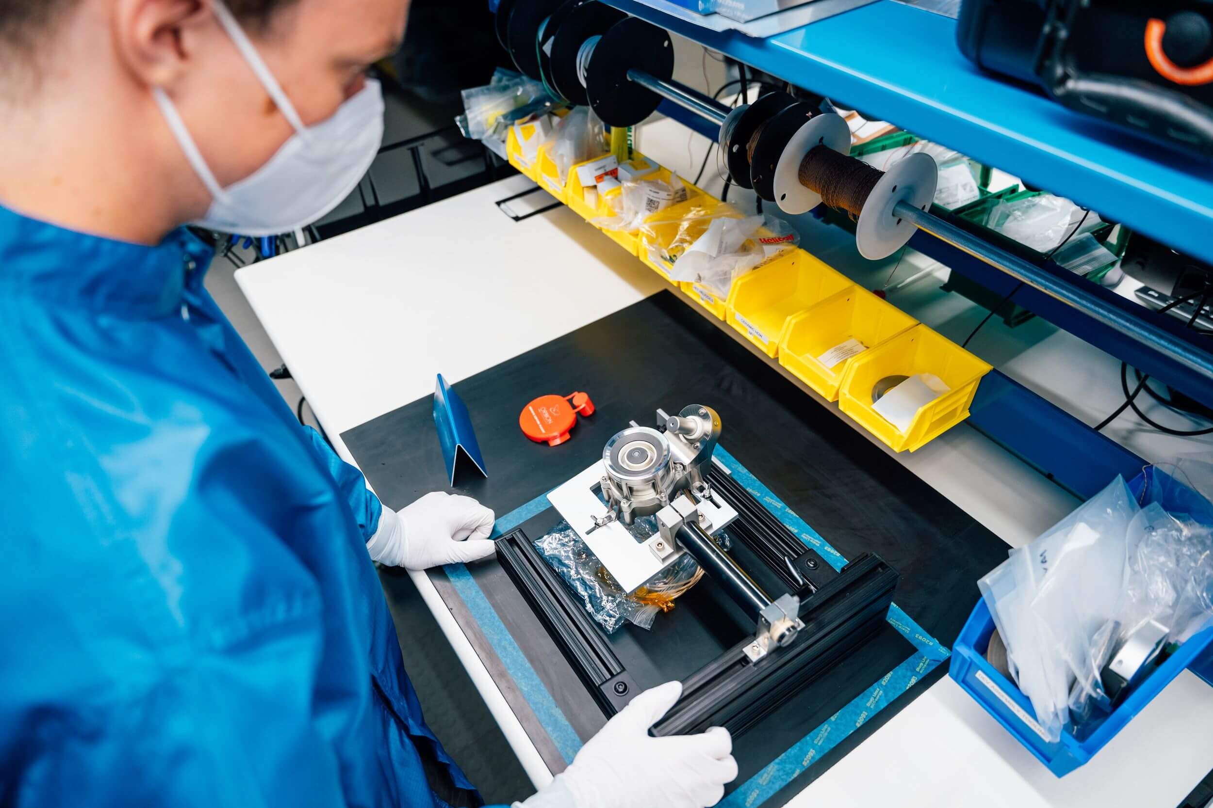 Women works on space technology tool in lab.