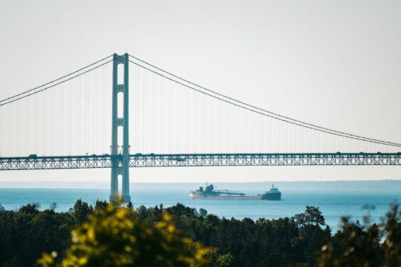 Freighter passing under the Mackinac Bridge.