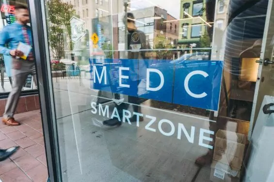 Sign displaying MEDC SmartZone on building window