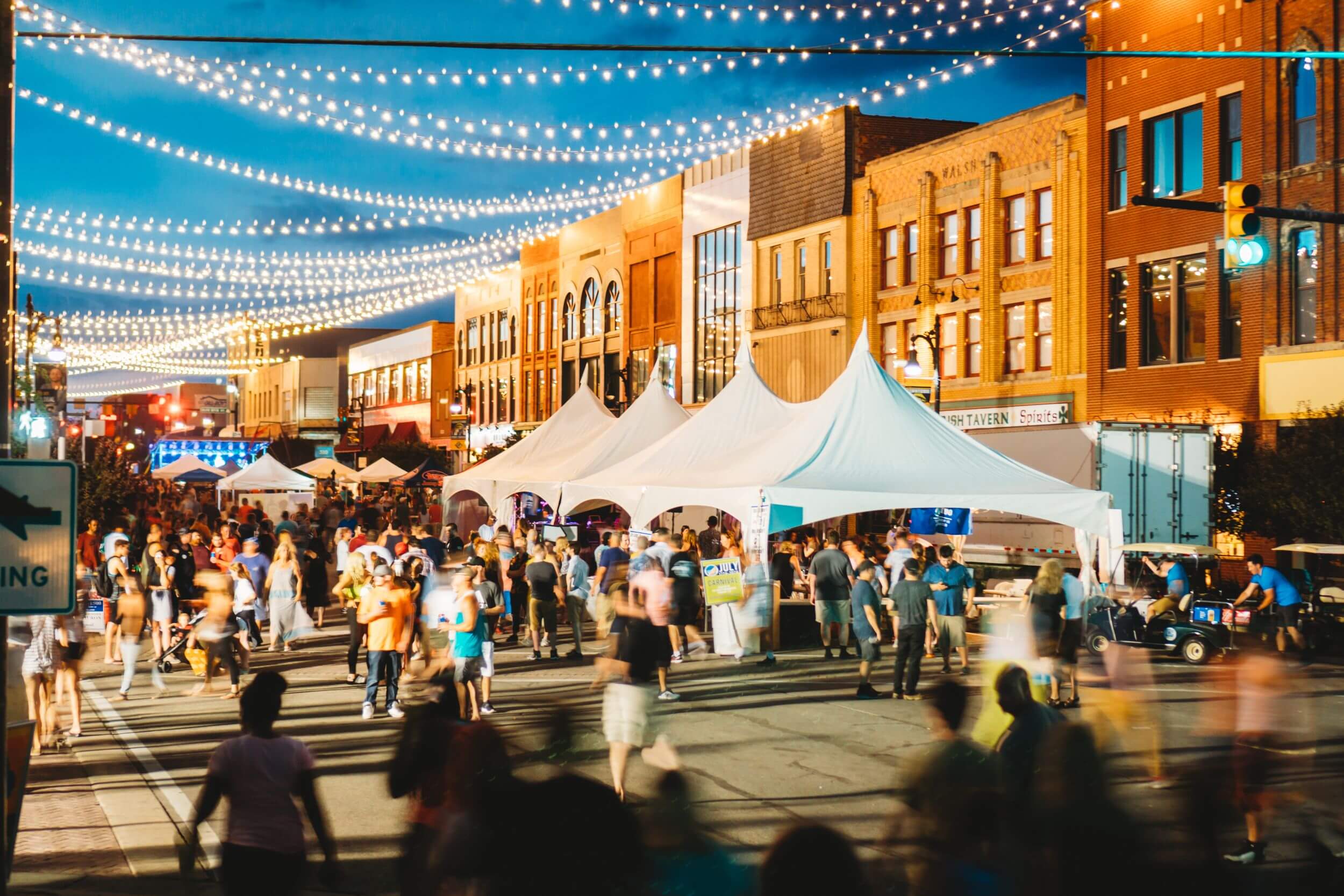 Main street in Port Huron with white tents and crowds of people during the Mackinac Race.