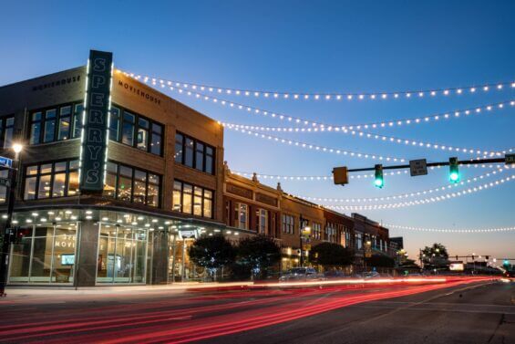 Cars drive by on a quaint street at sunset in Port Huron.